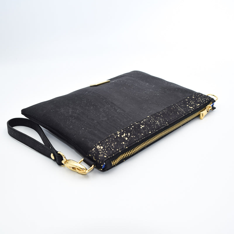 The Medlyn vegan cork leather clutch bag in black and gold. Comes with a wrist strap and shoulder strap so that it can also be a cross body bag. Cruelty free and peta approved.