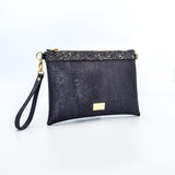 The Medlyn vegan cork leather clutch bag in black and gold. Comes with a wrist strap and shoulder strap so that it can also be a cross body bag. Cruelty free and peta approved.