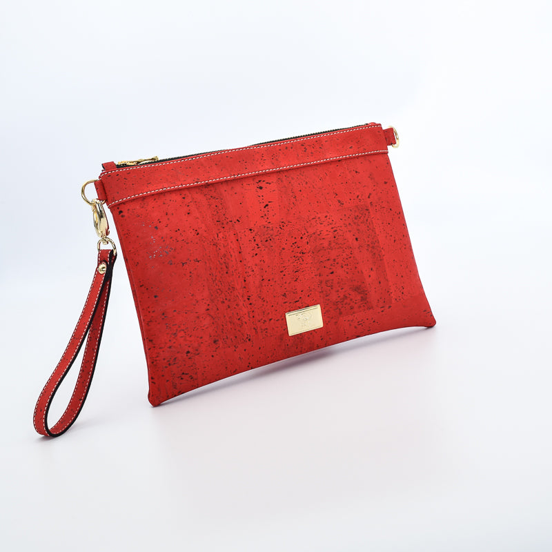 The Medlyn vegan cork leather clutch bag in Red. Comes with a wrist strap and shoulder strap so that it can also be a cross body bag. Cruelty free and peta approved.