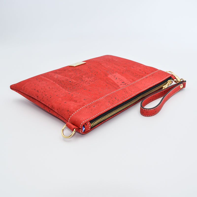 The Medlyn vegan cork leather clutch bag in Red. Comes with a wrist strap and shoulder strap so that it can also be a cross body bag. Cruelty free and peta approved.