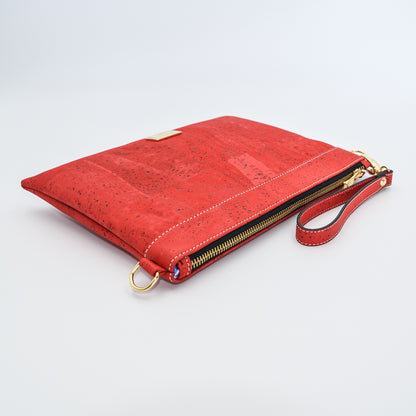 The Medlyn vegan cork leather clutch bag in Red. Comes with a wrist strap and shoulder strap so that it can also be a cross body bag. Cruelty free and peta approved.